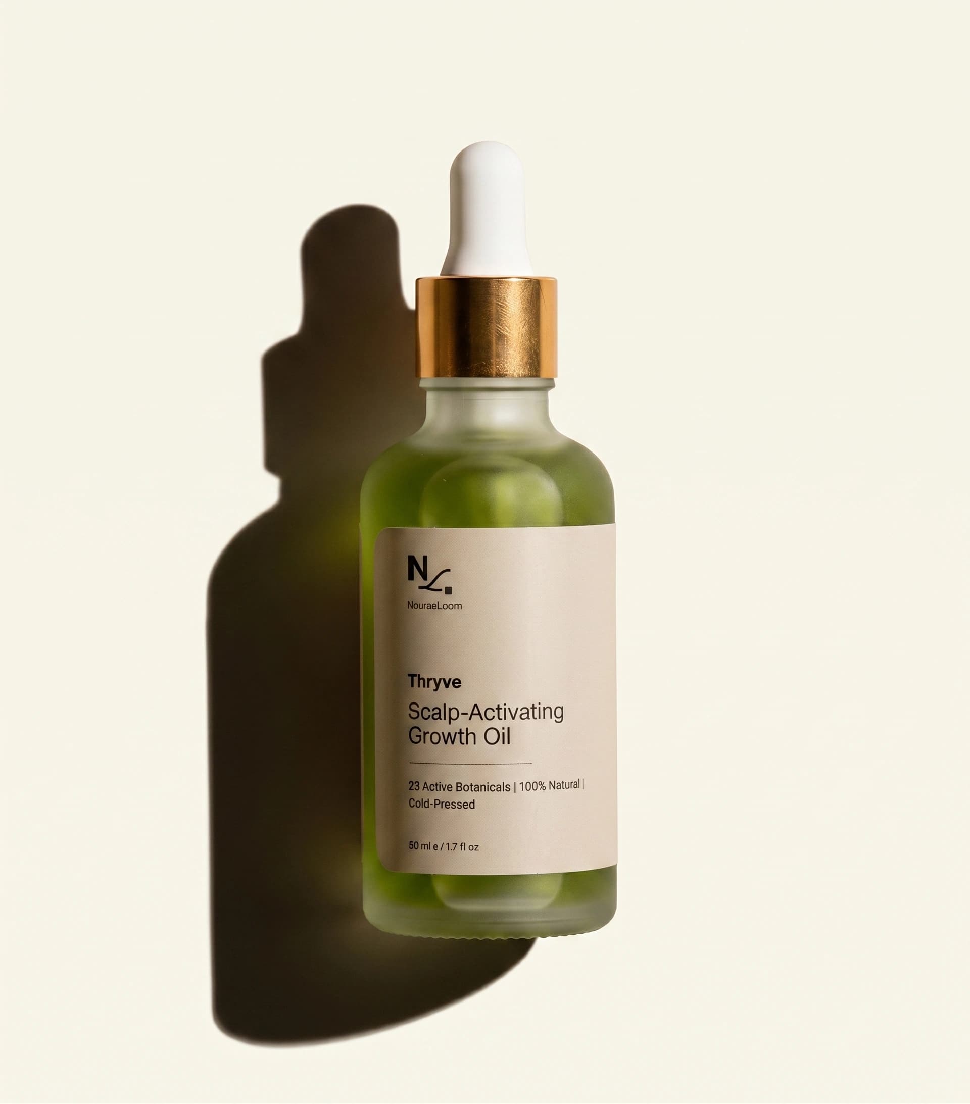 thryve bottle held in golden-hour light, yellowish-green oil visible through frosted glass